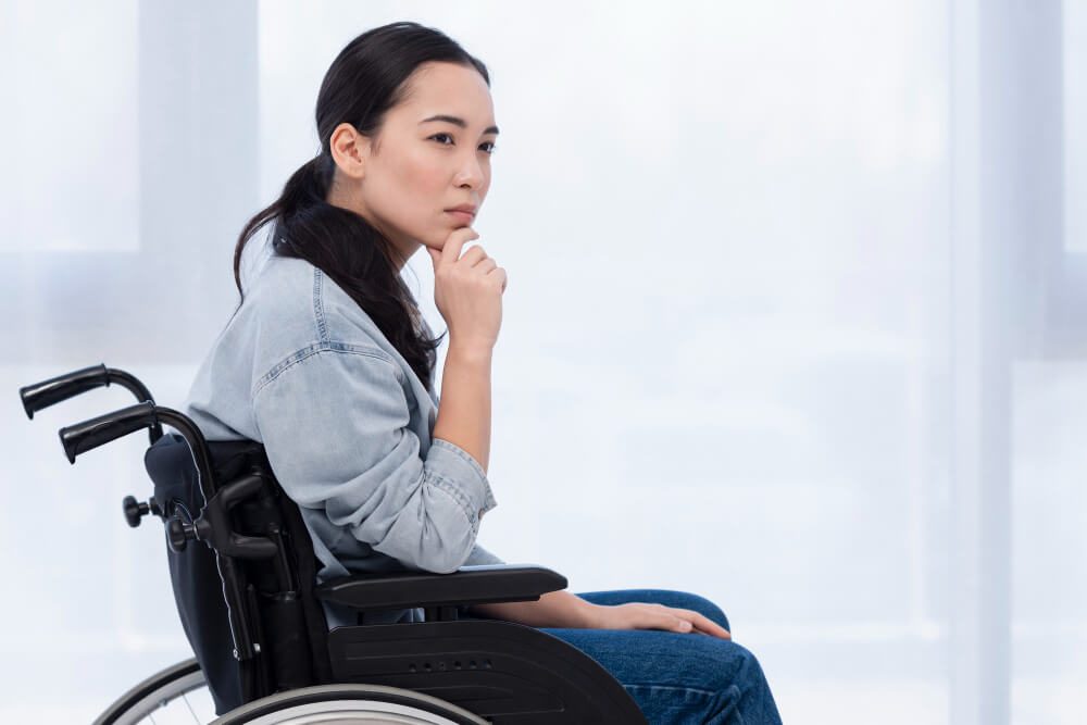a woman on a wheelchair having deep thoughts