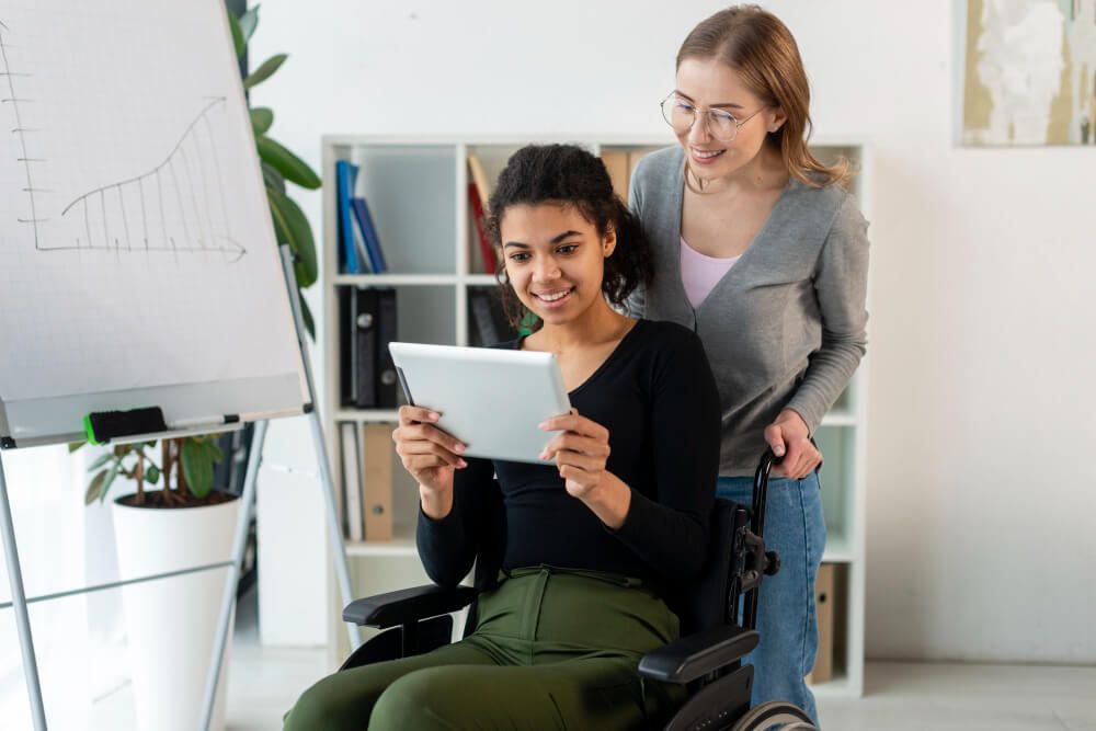 lady on a wheelchair browsing a tablet