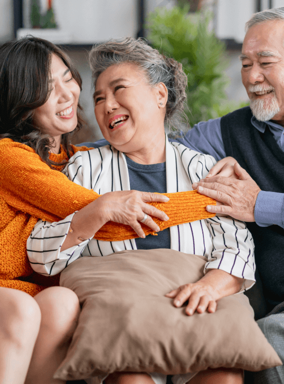 happy family laughing and hugging on a couch