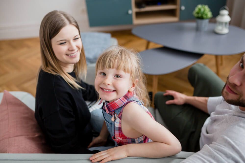 Happy family resting on sofa